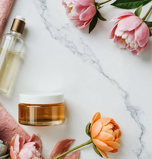 aesthetic-beauty-products-with-flowers-marble-background